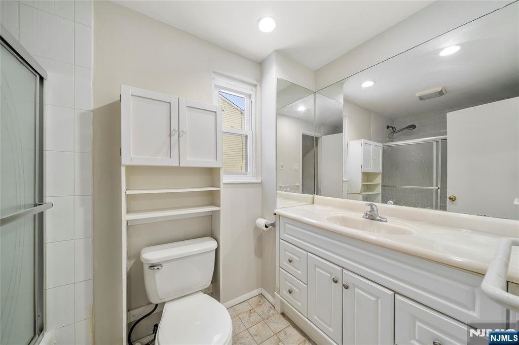 44 Knickerbocker Road Cresskill, NJ 07626 - Photo 15 of 26 a bathroom with a sink a toilet and a mirror