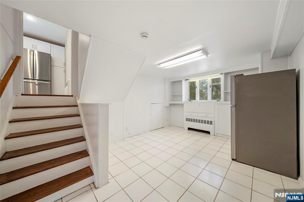 44 Knickerbocker Road Cresskill, NJ 07626 - Photo 19 of 26 a view of a livingroom with wooden floor and stairs
