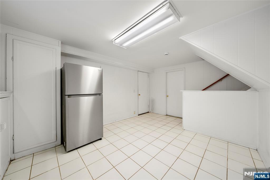 44 Knickerbocker Road Cresskill, NJ 07626 - Photo 20 of 26 a view of a refrigerator in kitchen and empty room
