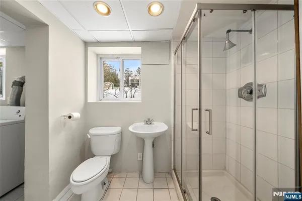 a bathroom with a toilet sink a shower and a mirror