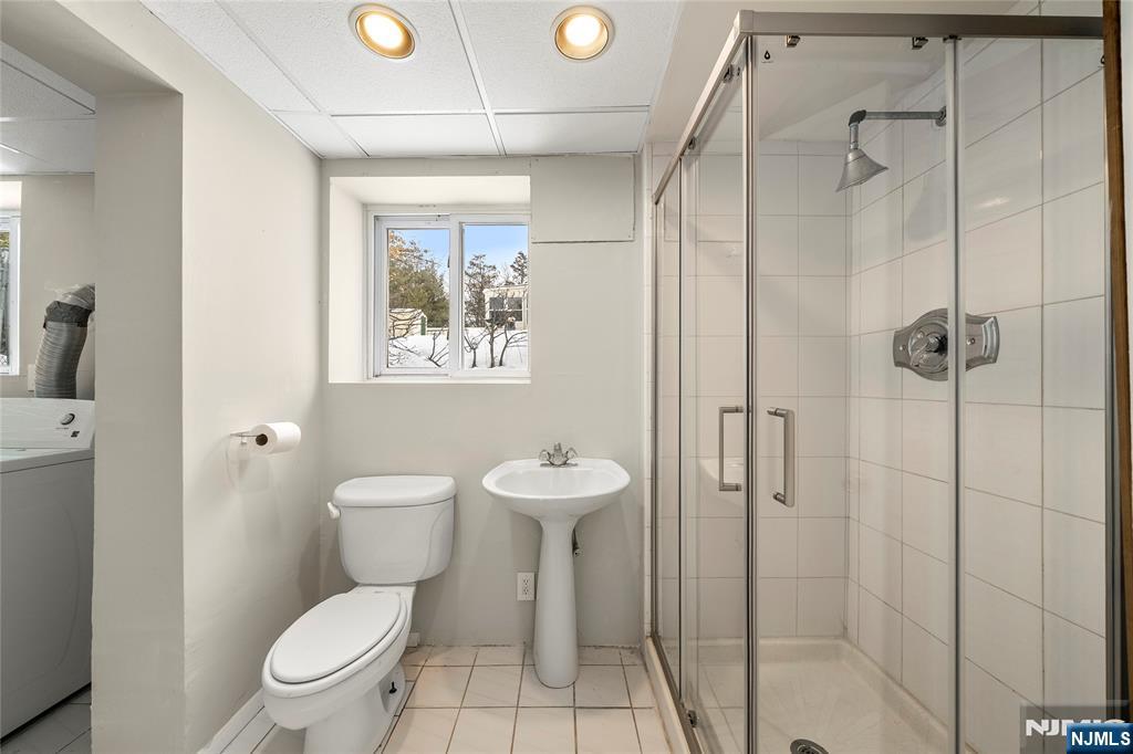 44 Knickerbocker Road Cresskill, NJ 07626 - Photo 21 of 26 a bathroom with a toilet sink a shower and a mirror