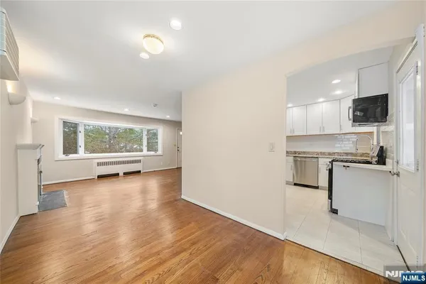 a view of a kitchen with a sink a stove and microwave