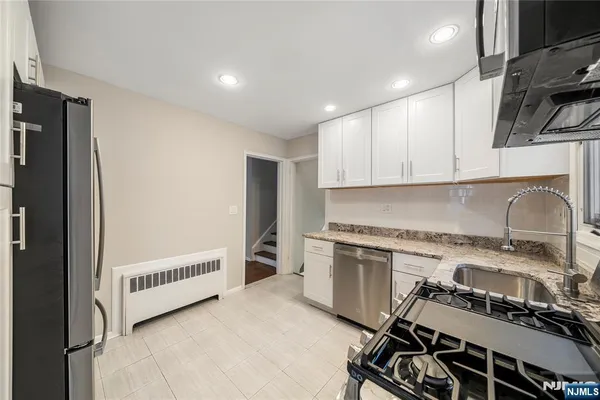 a kitchen with a stove a sink and a refrigerator