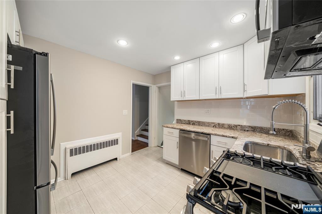 44 Knickerbocker Road Cresskill, NJ 07626 - Photo 8 of 26 a kitchen with a stove a sink and a refrigerator