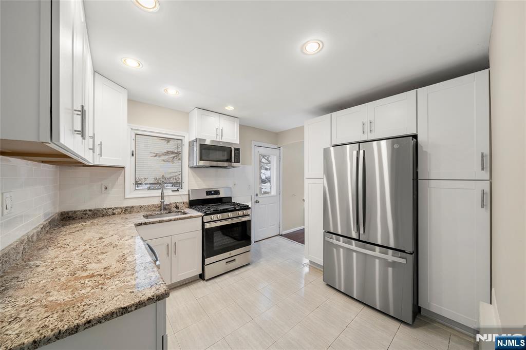 44 Knickerbocker Road Cresskill, NJ 07626 - Photo 10 of 26 a kitchen with granite countertop stainless steel appliances and refrigerator