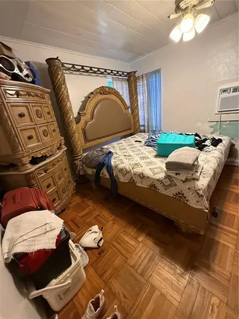 a bedroom with bed and wooden floor
