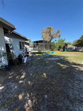 a view of a house with backyard and sitting area