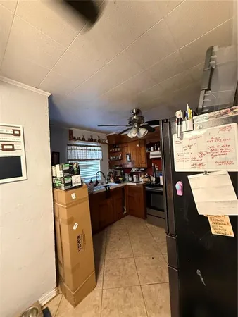 a kitchen with stainless steel appliances kitchen island granite countertop a sink counter space and cabinets