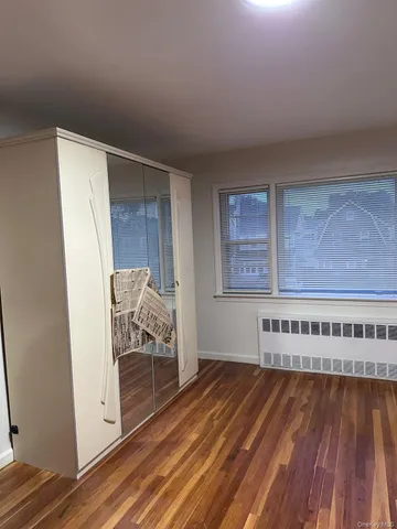 a view of a room with wooden floor