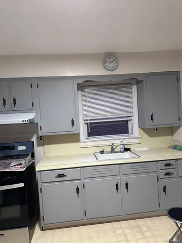 a kitchen with appliances cabinets and a sink