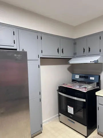 a stove top oven sitting inside of a kitchen