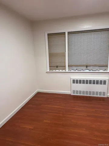 a view of a room with wooden floor and window