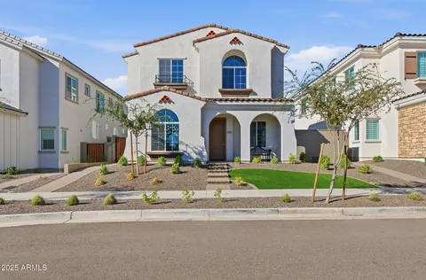 a view of a white house with a street