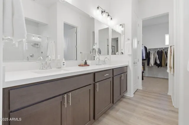 a view of walk in closet with clothes and shoes