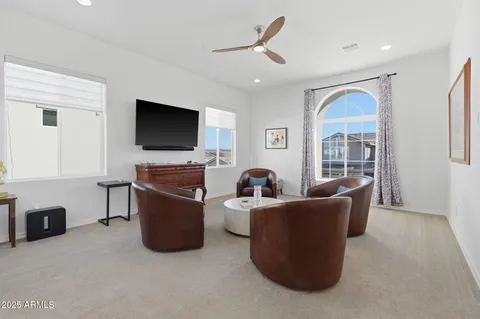 a bedroom with a bed and a lamp on the dresser