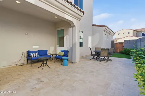 a front view of a house with a garden and trees