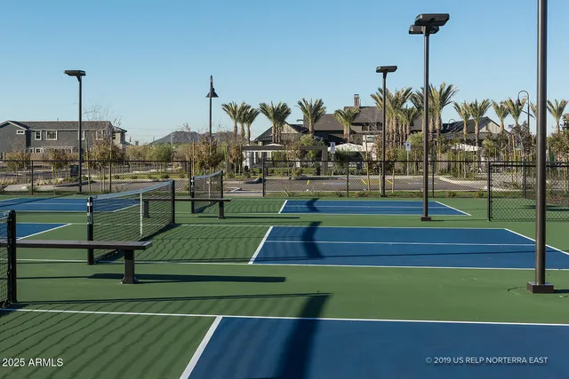 a view of a patio with couches table and chairs and potted plants