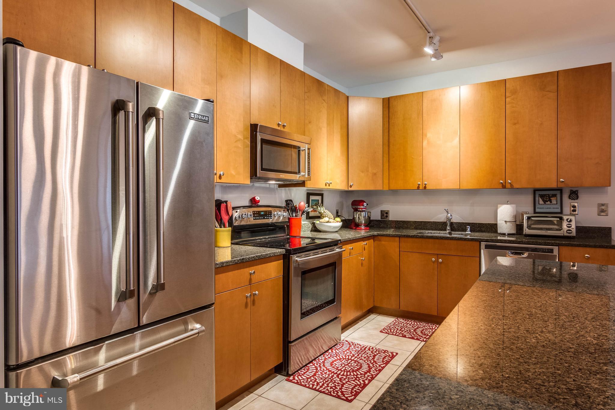 2007 Clipper Park Road, Unit 319 Baltimore, MD 21211 - Photo 15 of 29 a kitchen with stainless steel appliances granite countertop a refrigerator stove top oven and sink