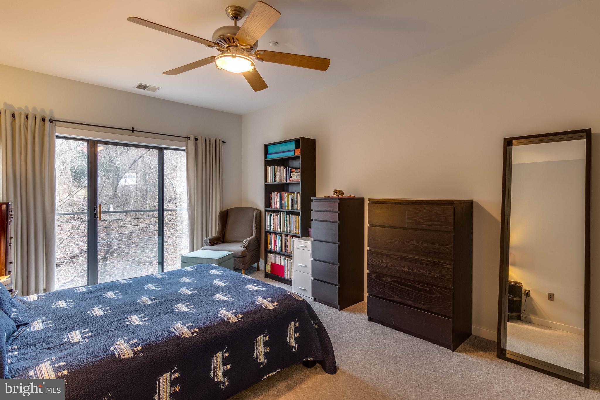 2007 Clipper Park Road, Unit 319 Baltimore, MD 21211 - Photo 19 of 29 a bedroom with a bed closet and a large window