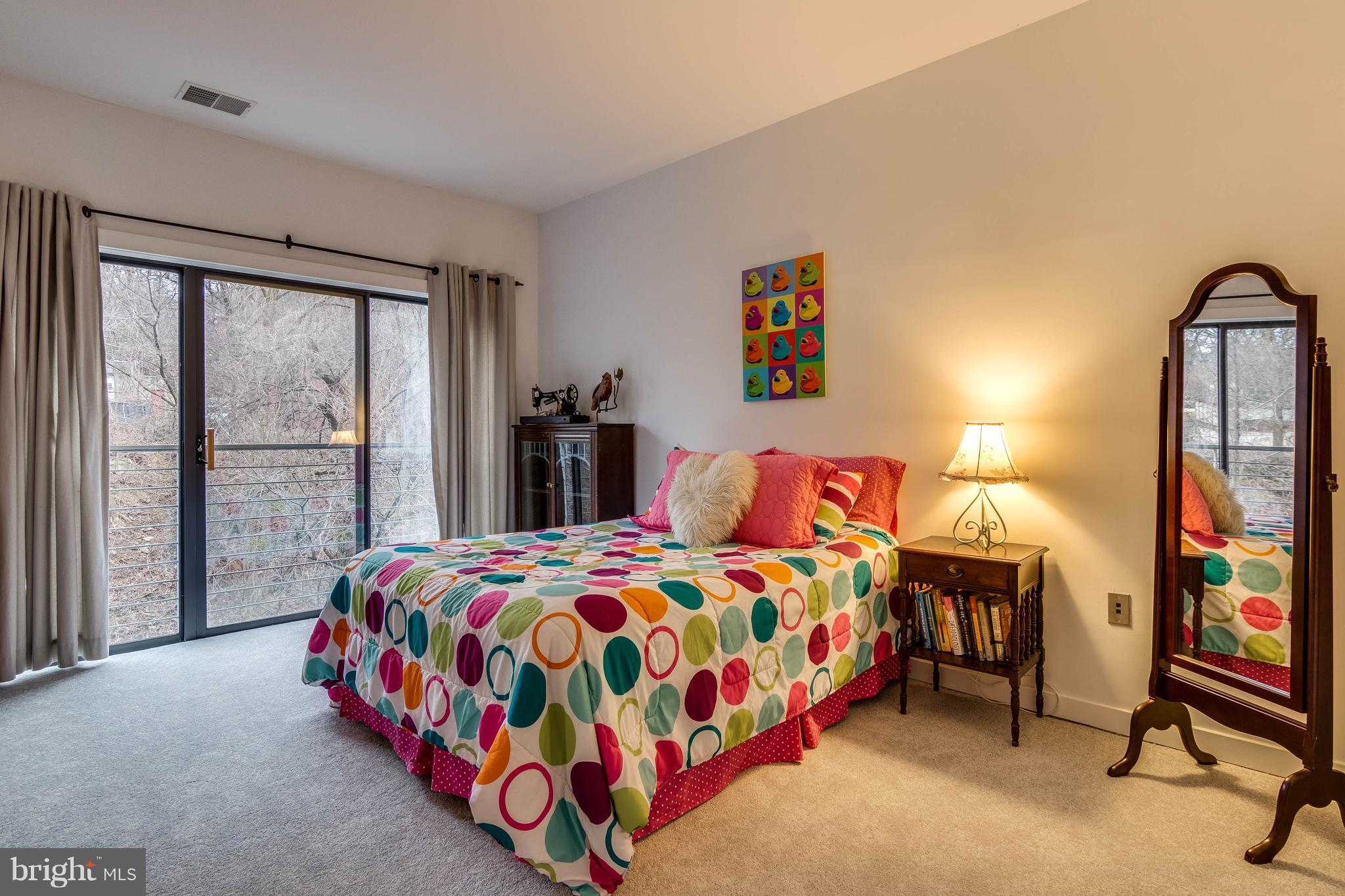 2007 Clipper Park Road, Unit 319 Baltimore, MD 21211 - Photo 23 of 29 a bedroom with a bed and a dresser next to a window