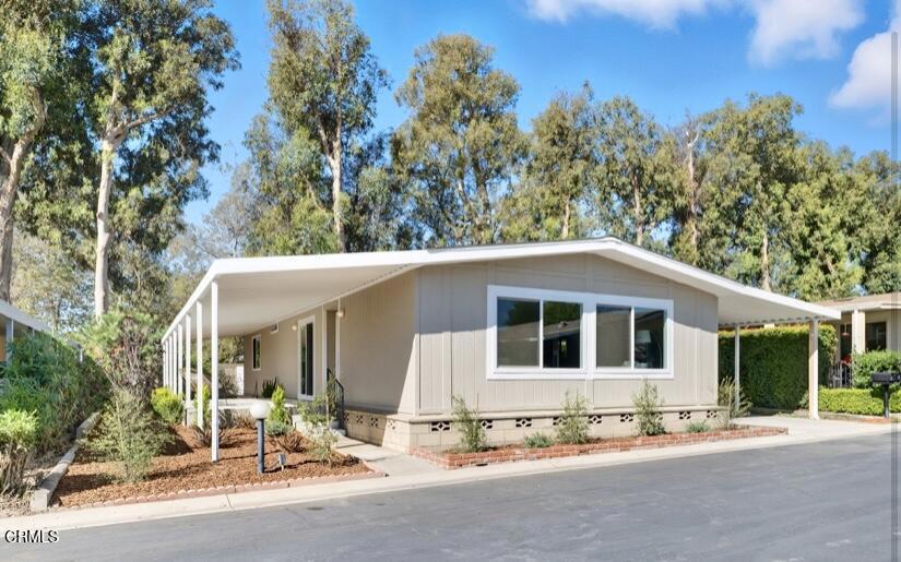 4700 Aurora Drive, Unit 16 Ventura, CA 93003 - Photo 1 of 28 a front view of a house with a yard and garage