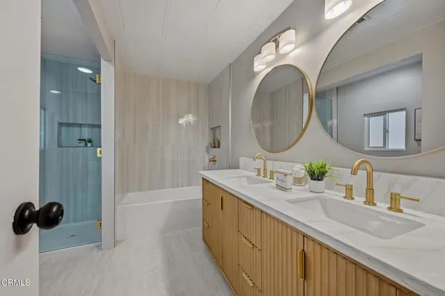 a bathroom with a double vanity sink and a mirror