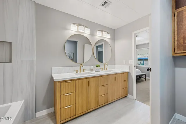 a bathroom with a double vanity sink and a mirror