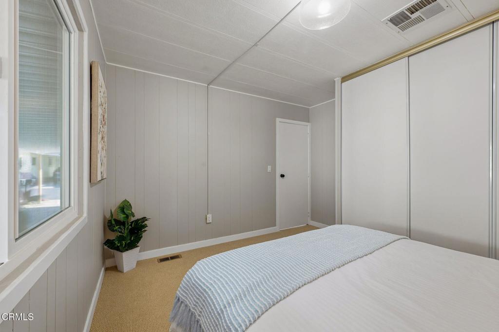4700 Aurora Drive, Unit 16 Ventura, CA 93003 - Photo 14 of 28 a bedroom with a bed and a potted plant