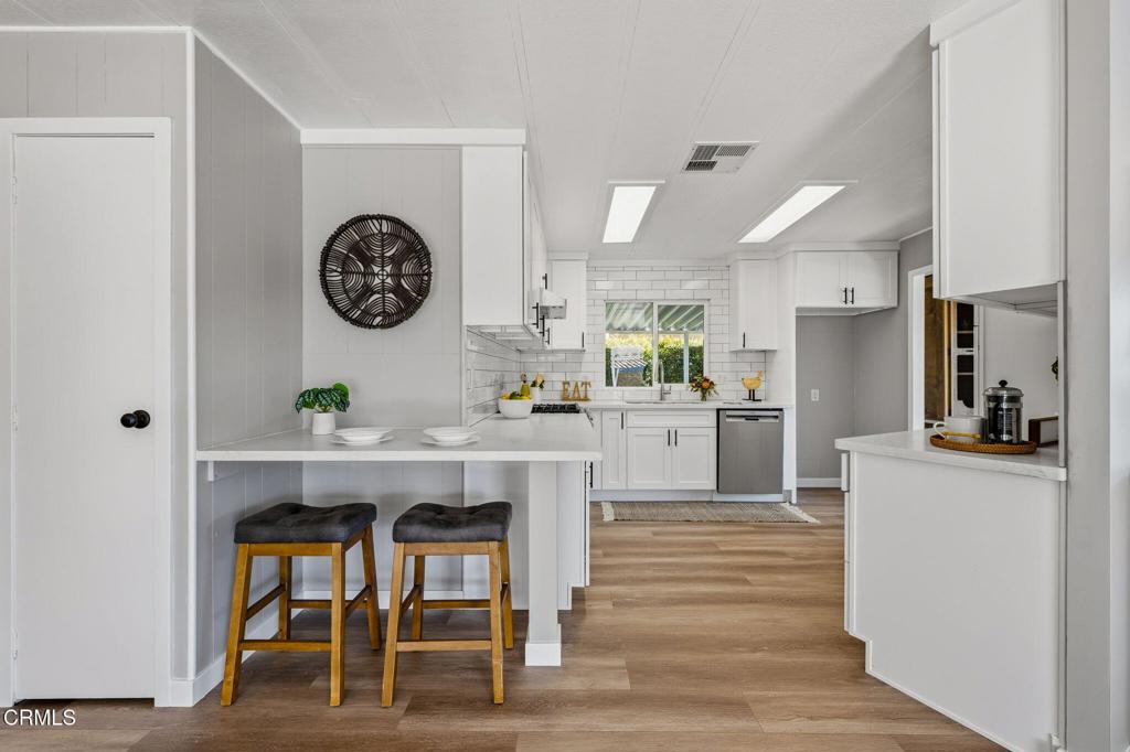 4700 Aurora Drive, Unit 16 Ventura, CA 93003 - Photo 16 of 28 a kitchen with a table and chairs in it