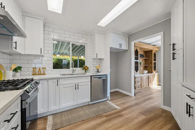a kitchen with a sink stove and refrigerator
