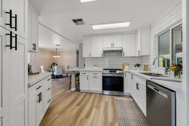 a kitchen with a sink stove and cabinets
