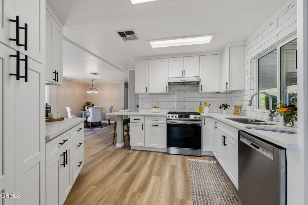 4700 Aurora Drive, Unit 16 Ventura, CA 93003 - Photo 18 of 28 a kitchen with a sink stove and cabinets