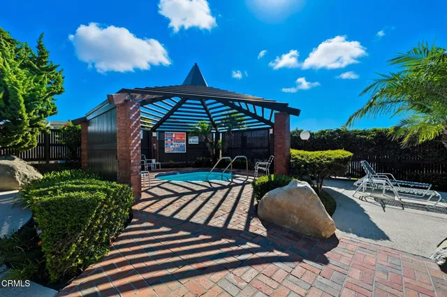 a view of a porch with chairs and potted plants