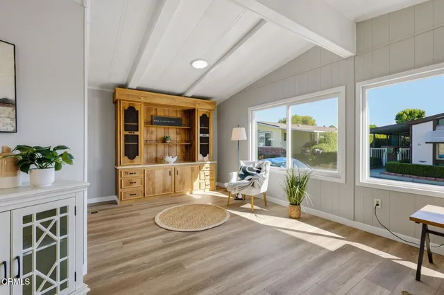 a room with wooden floor table and chairs