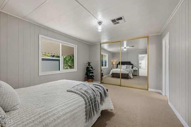 a large bedroom with a bed and window