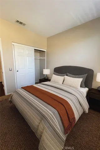 a bedroom with a bed and a night stand