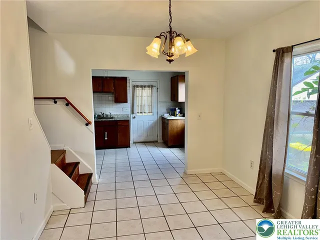 a kitchen with stainless steel appliances a sink a stove a refrigerator and cabinets