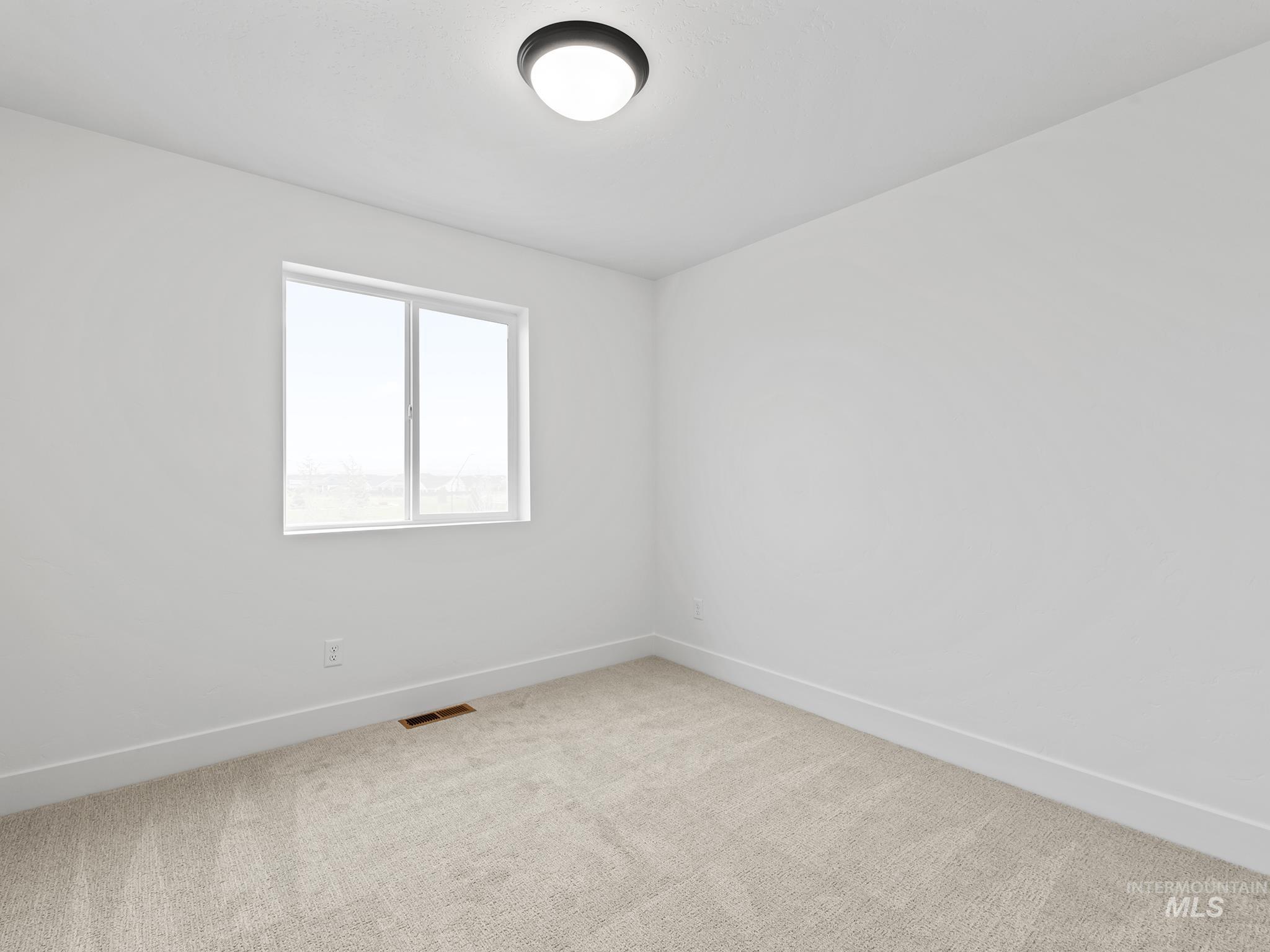 2168 East Deep Purple Lane Meridian, ID 83642 - Photo 12 of 15 Empty room with baseboards and light colored carpet