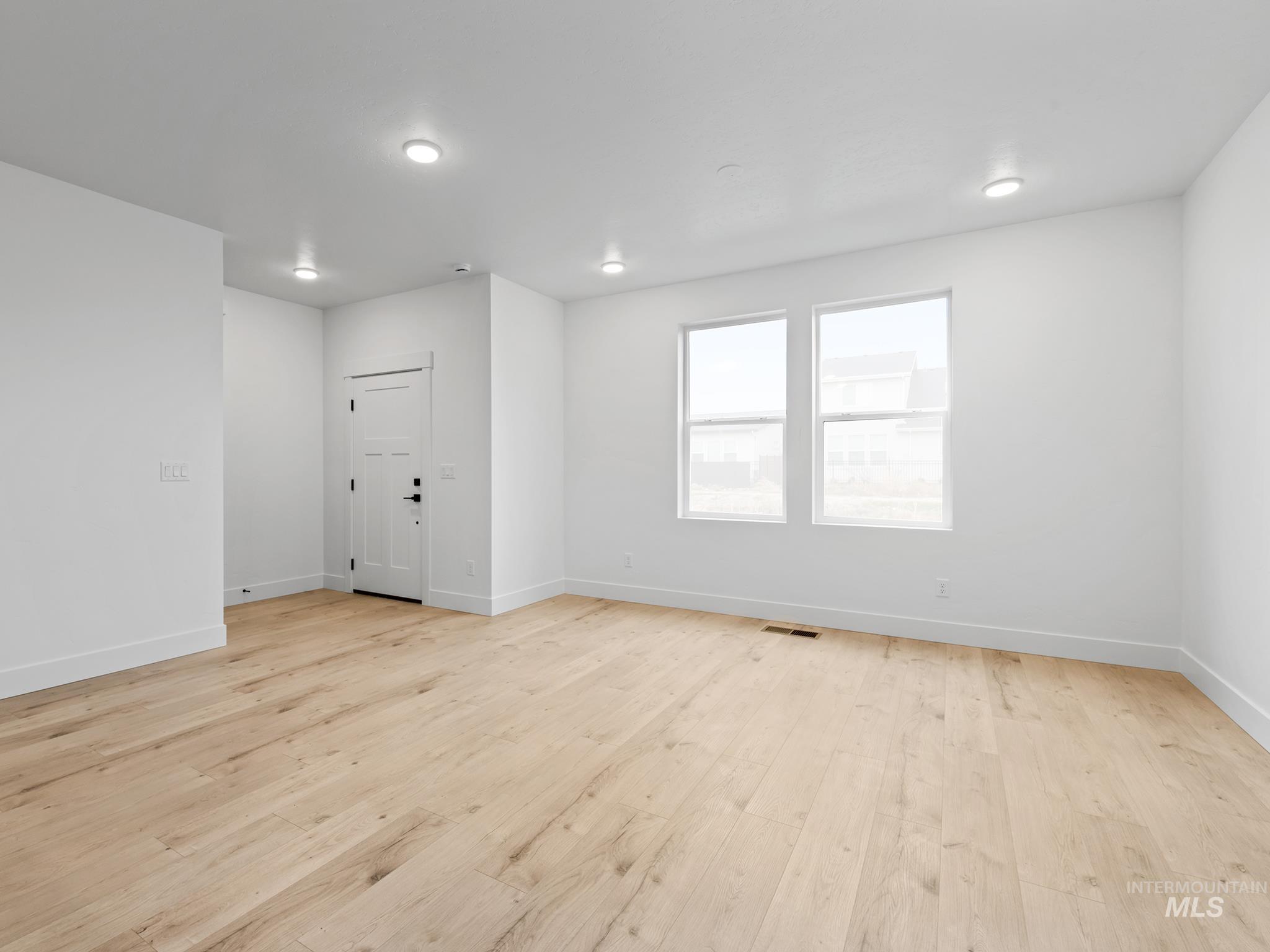 2168 East Deep Purple Lane Meridian, ID 83642 - Photo 5 of 15 Empty room featuring light wood-style flooring and baseboards