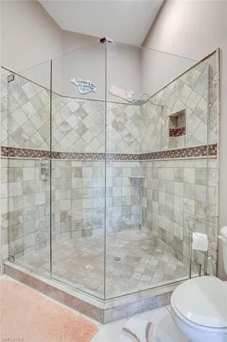 a bathroom with a shower and a toilet