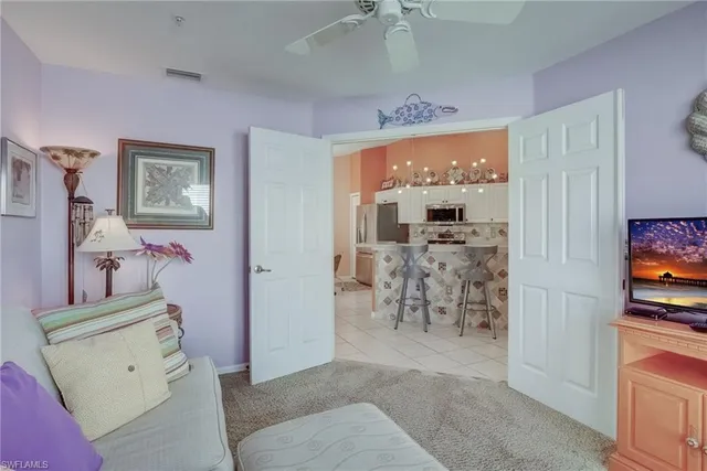 a view of a livingroom with furniture flat screen tv and couches