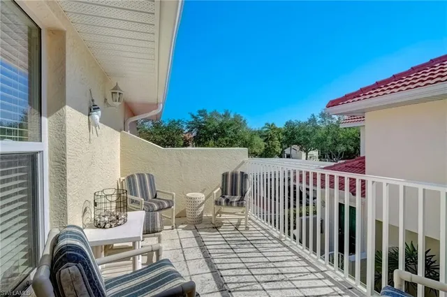a view of a balcony with furniture
