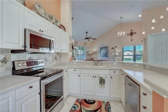 a kitchen with a sink stove and microwave