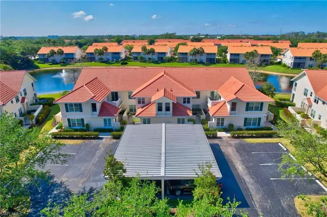 an aerial view of a house with a yard and potted plants