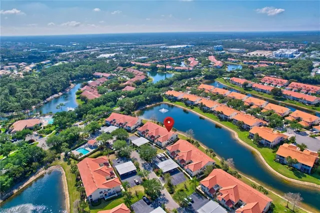 an aerial view of residential houses with outdoor space and seating