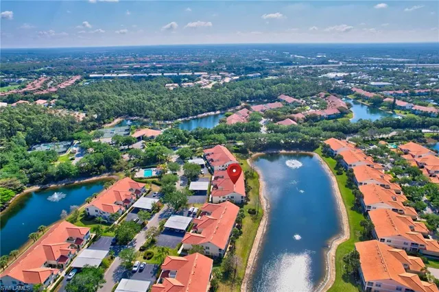 an aerial view of residential houses with outdoor space and swimming pool