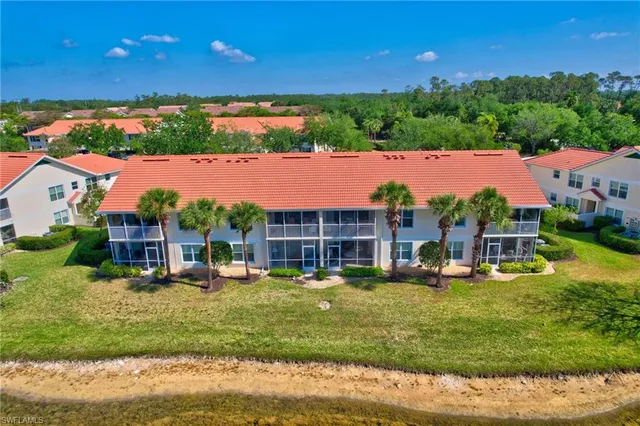 an aerial view of a house with a garden and houses