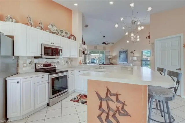 a kitchen with granite countertop a sink cabinets and stainless steel appliances
