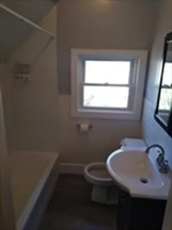 a bathroom with a sink toilet and a mirror