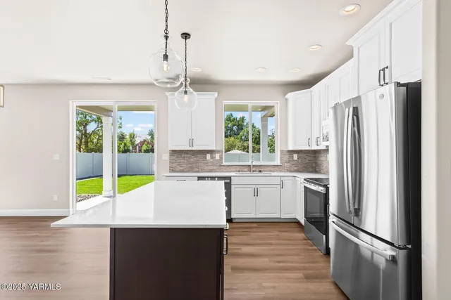 a kitchen with kitchen island a counter appliances and cabinets